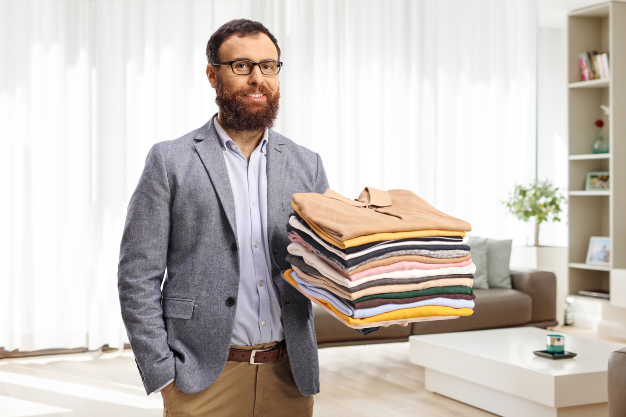 Nashville professional holding fresh laundry from delivery service