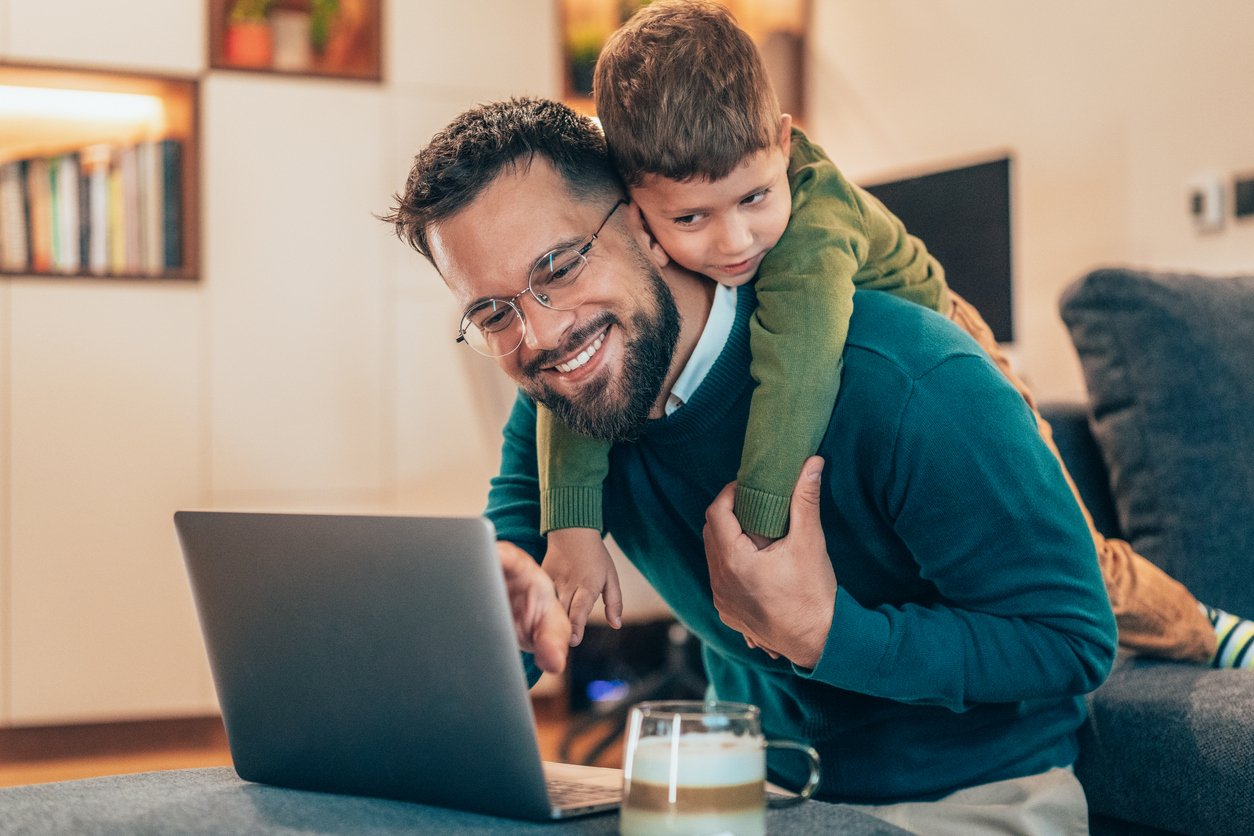 Father spending time with his son at home instead of doing laundry
